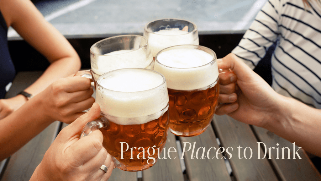 Friends clink beer glasses together in Prague.